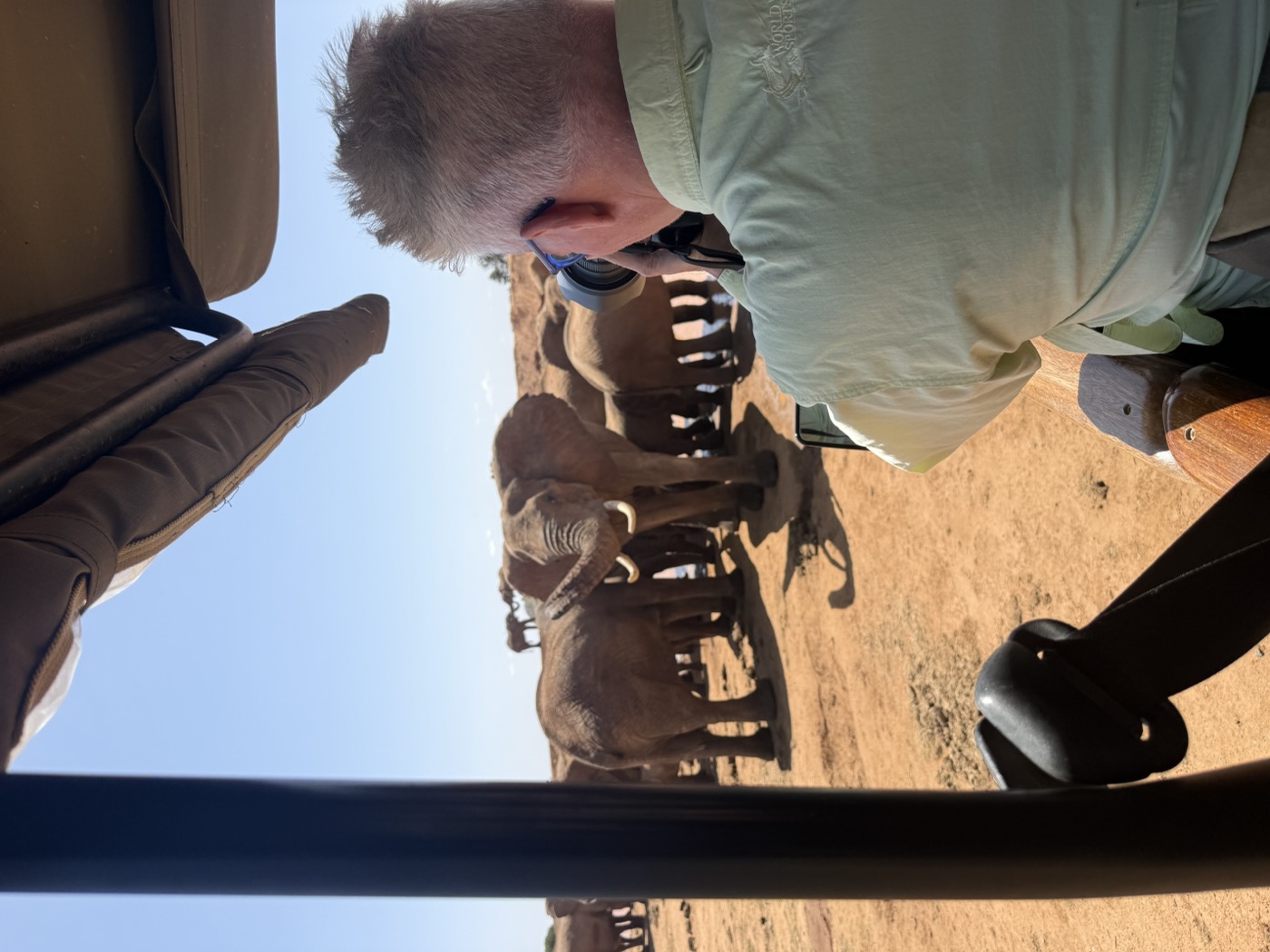 Harry Martin photographing a herd of elephants from a safari vehicle in Kenya