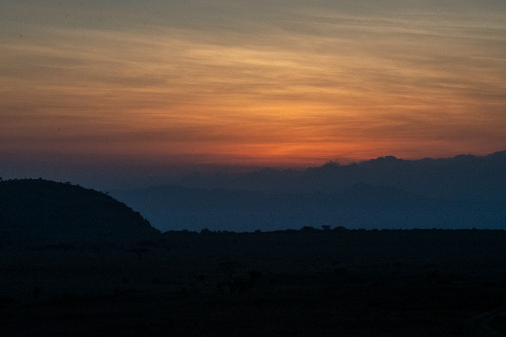 Layered mountain silhouettes at sunset