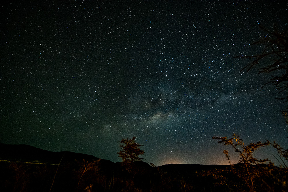 The Milky Way stretching over silhouetted Laikipia hills
